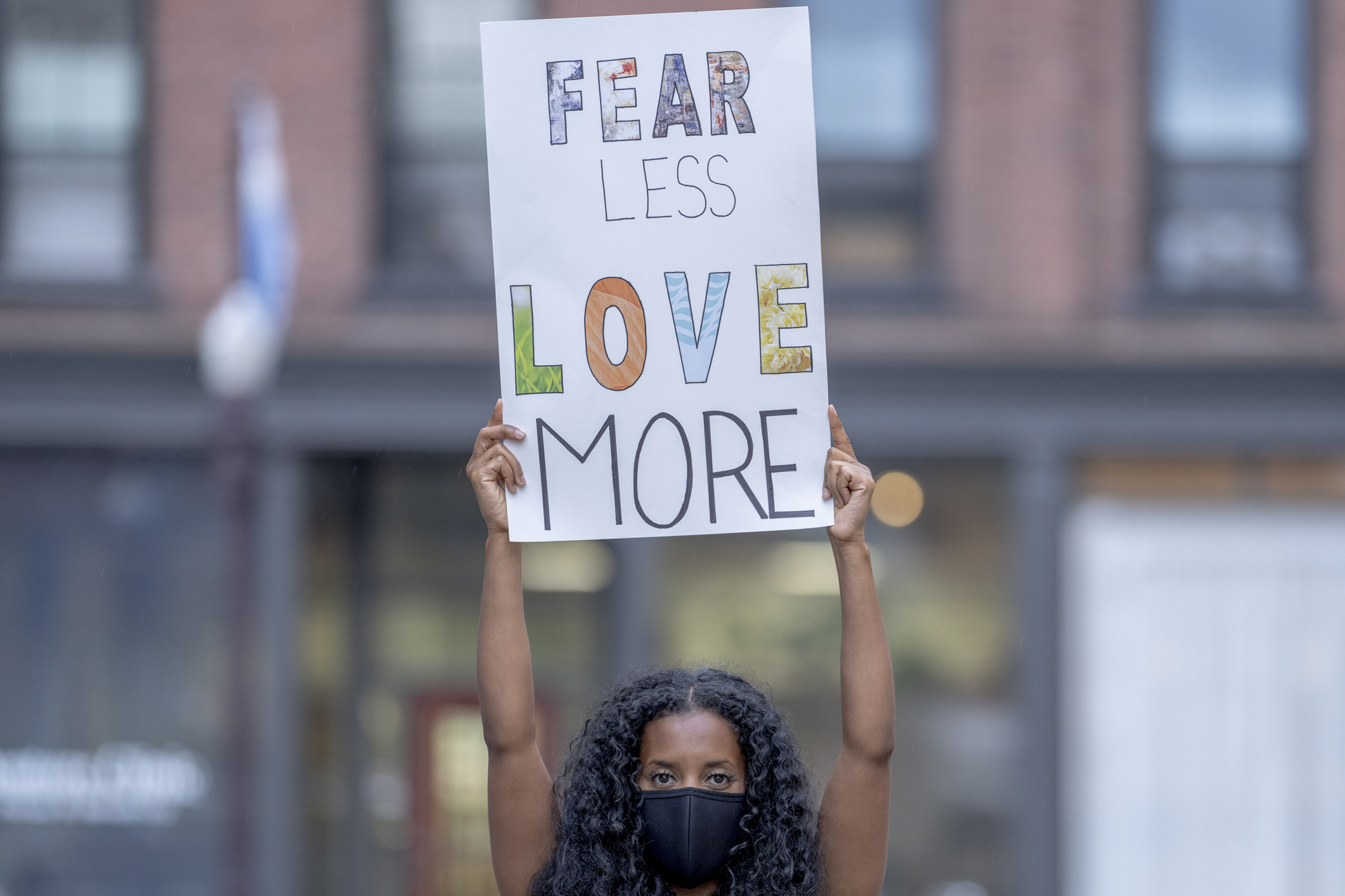 Beautiful African American woman holding a protest sign
