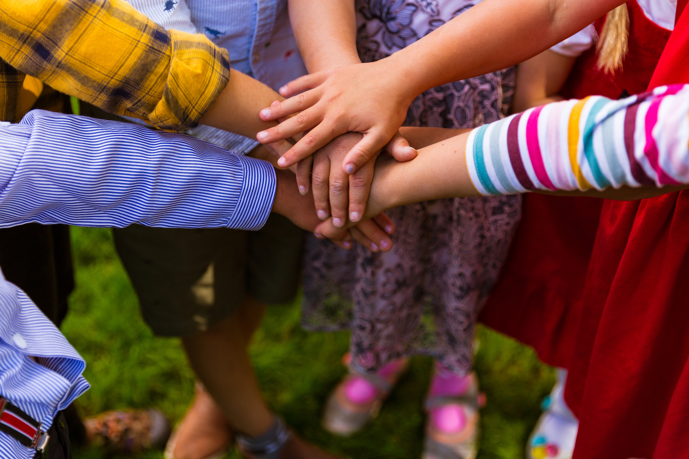 Kids joining hands together