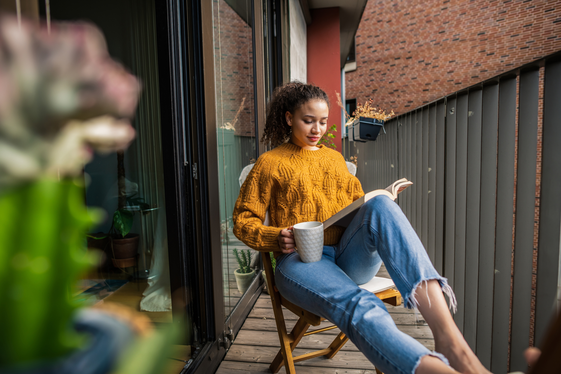 Young woman reading a book at home