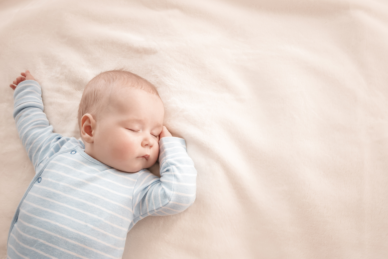 Baby boy sleeping covered with soft blanket
