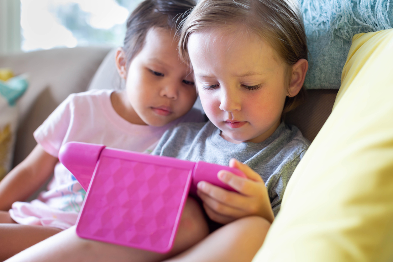 Kids watching tv on tablet at home. Online education.
