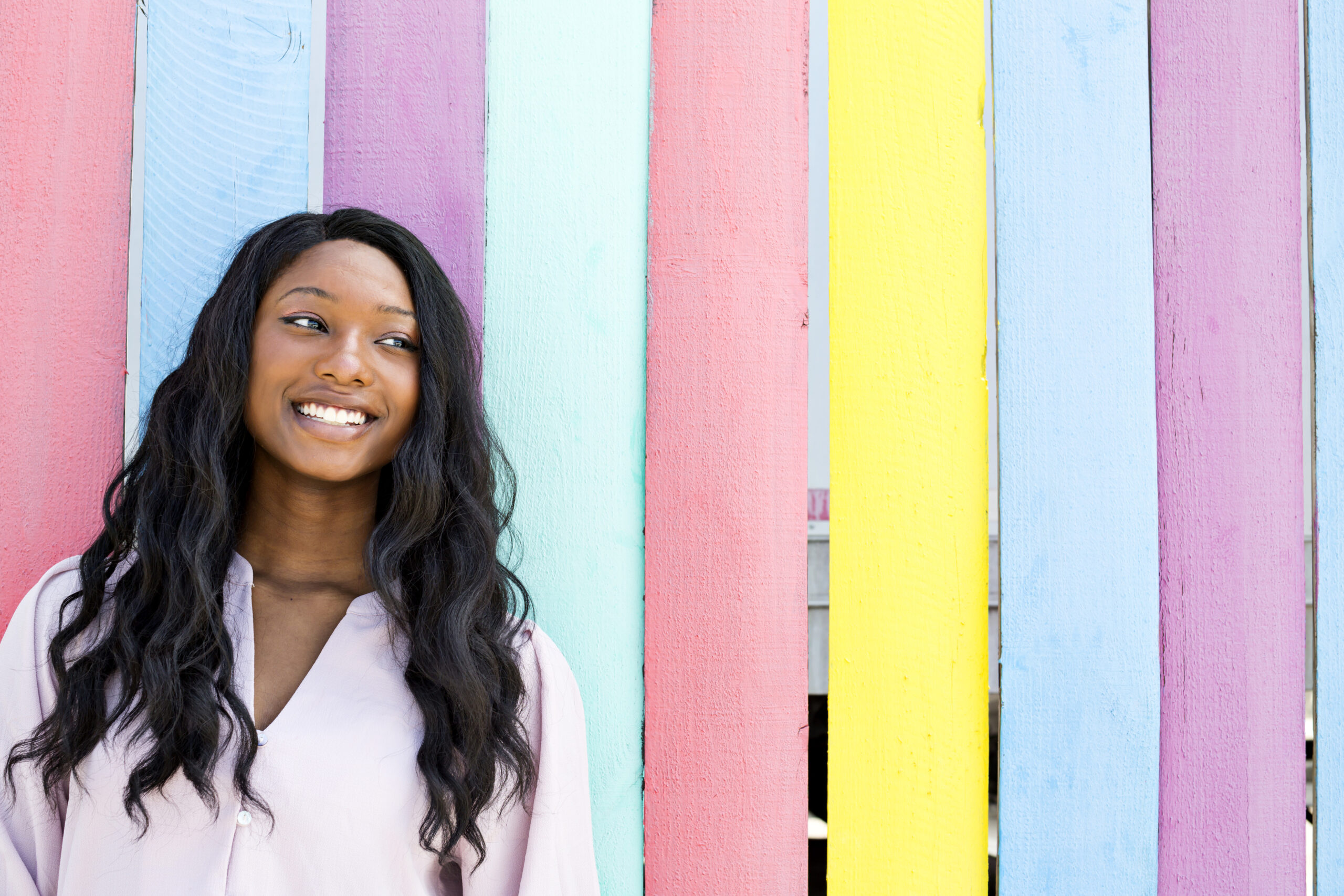 Confident and stunning teen outdoors infront of neon-colored wall