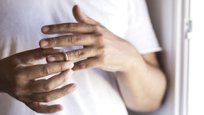 man taking off wedding ring