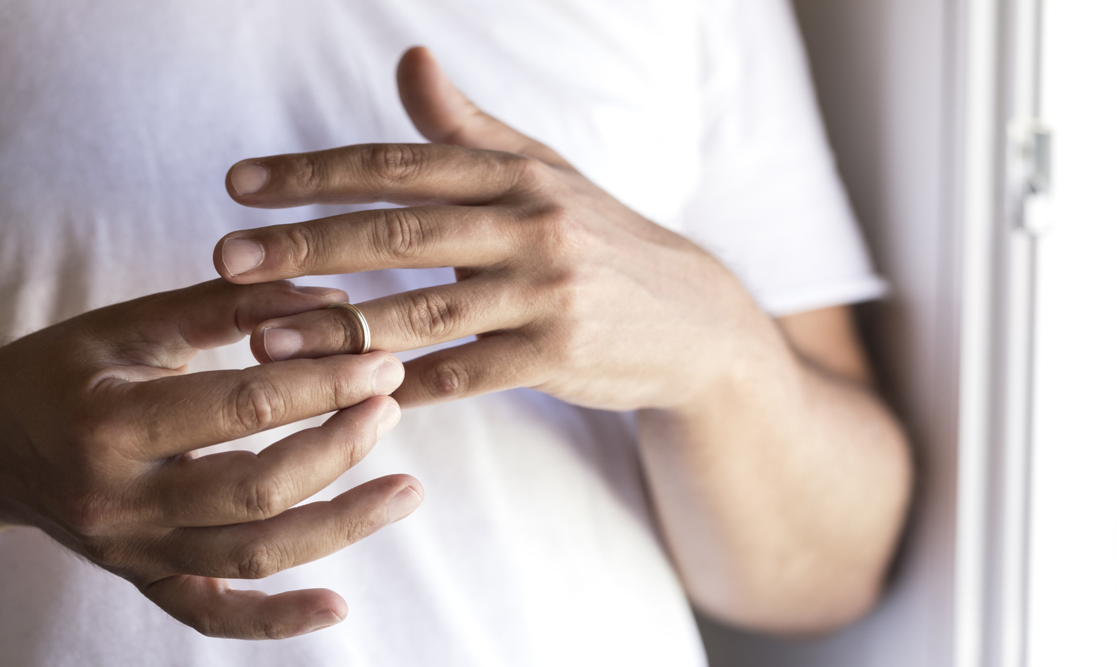 man taking off wedding ring