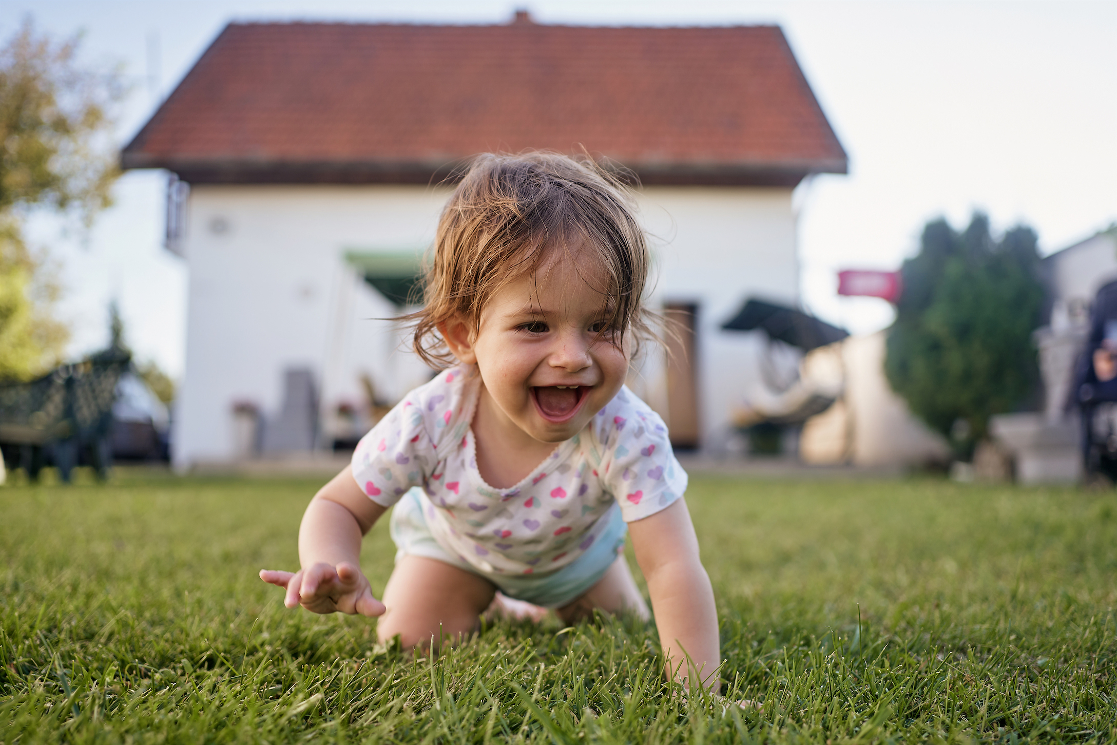 baby girl crawling in the grass