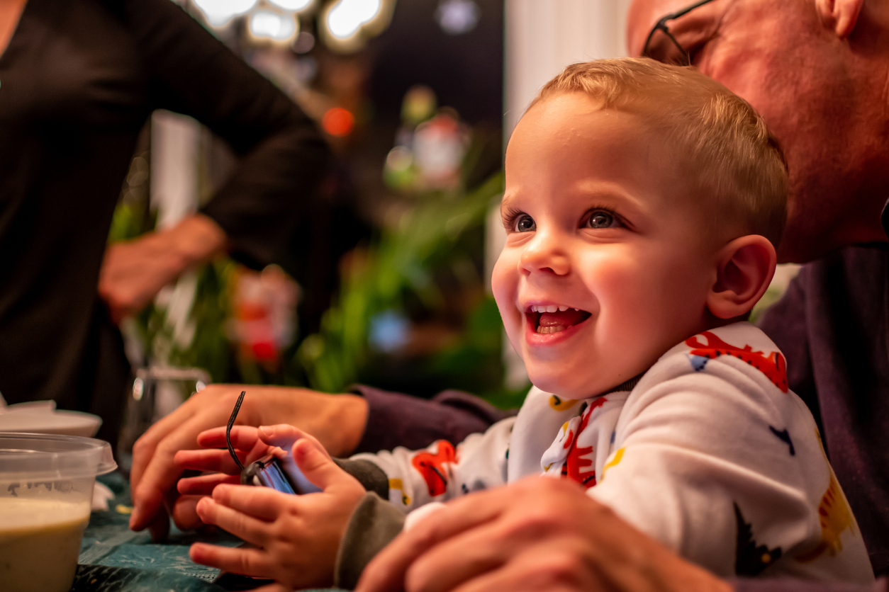 Toddler having a good time with his grandfather.