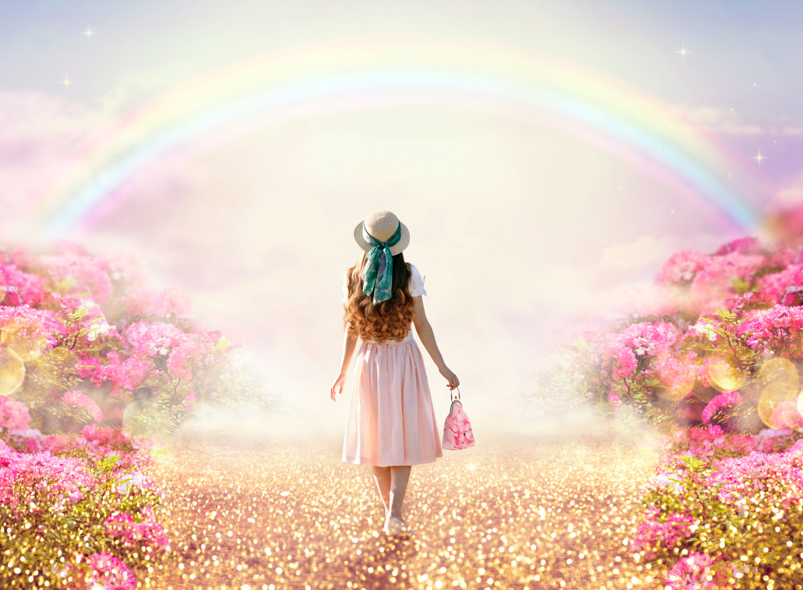 woman walking through beautiful sprig field and rainbows