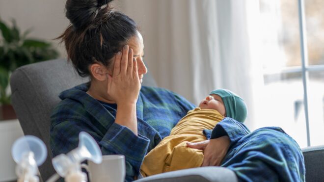 tired woman breastfeeding