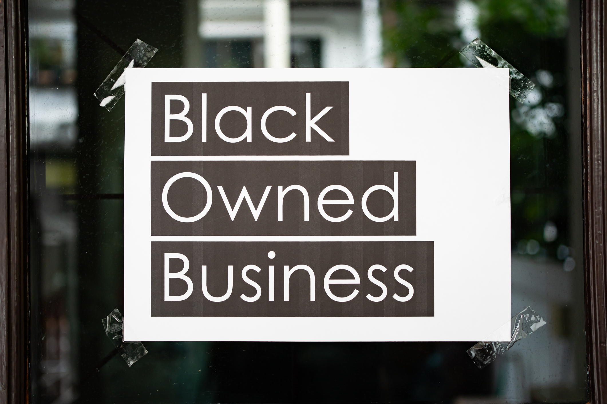 Black owned business sign attached on the window