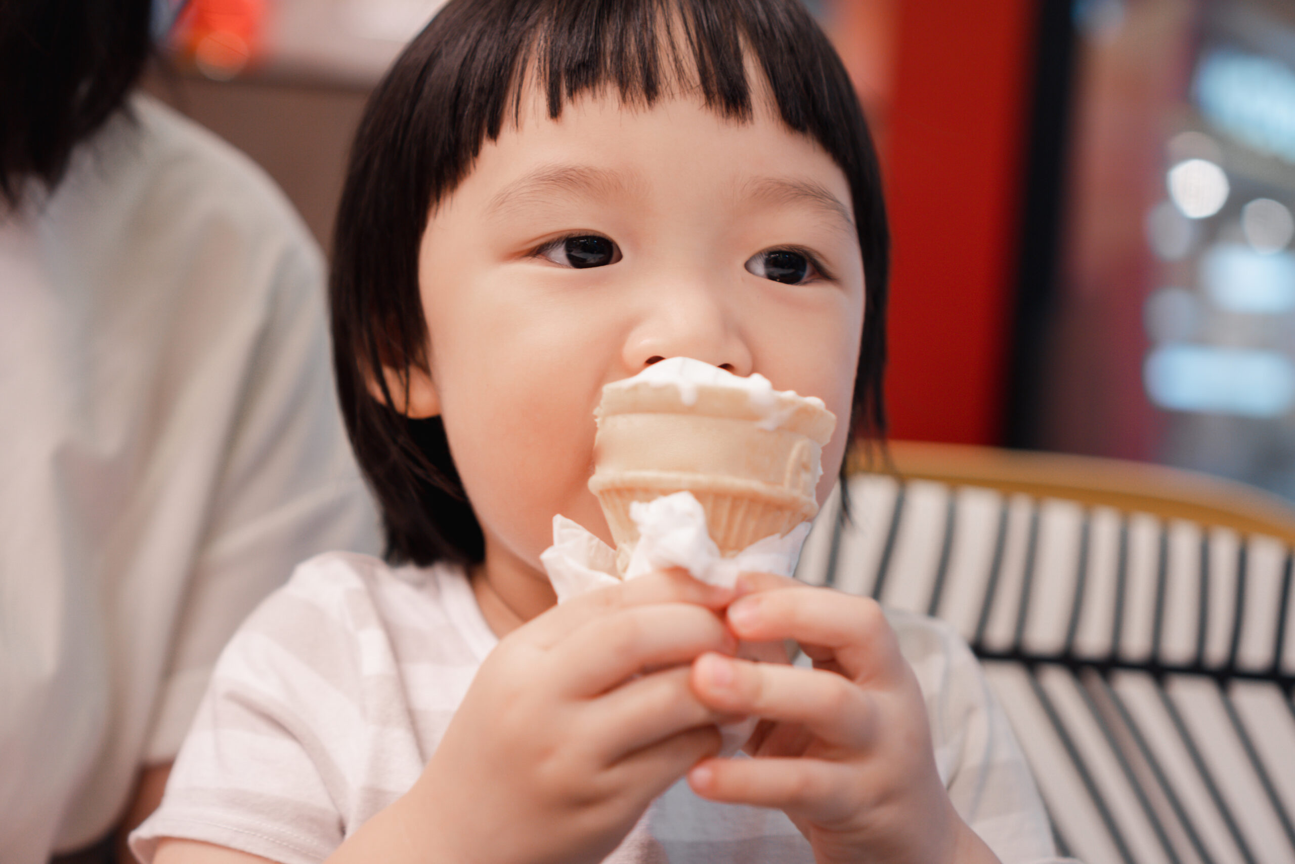 young asian kid eating ice cream