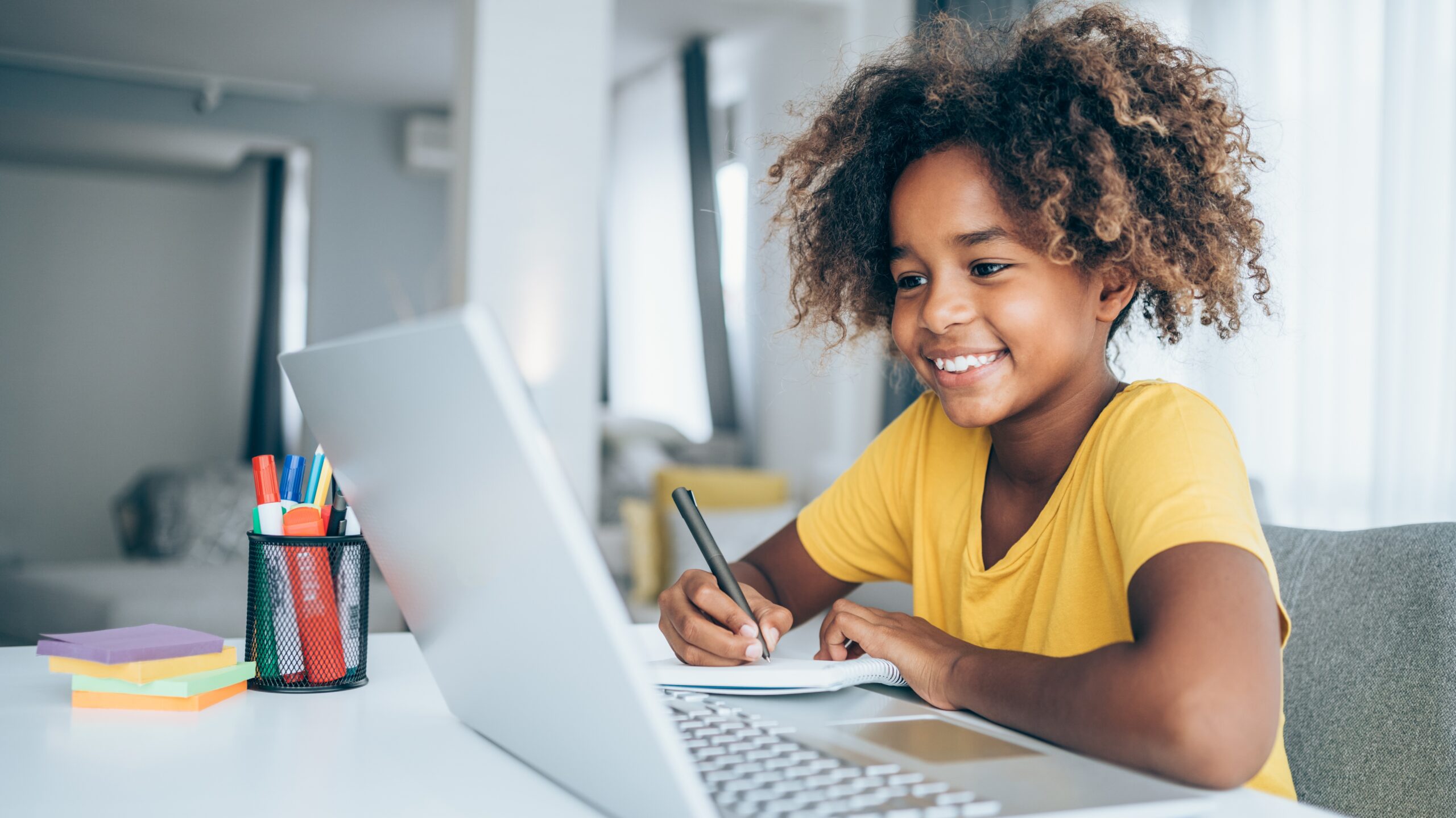 girl doing remote school at home