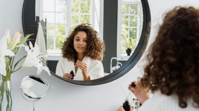woman looking in mirror