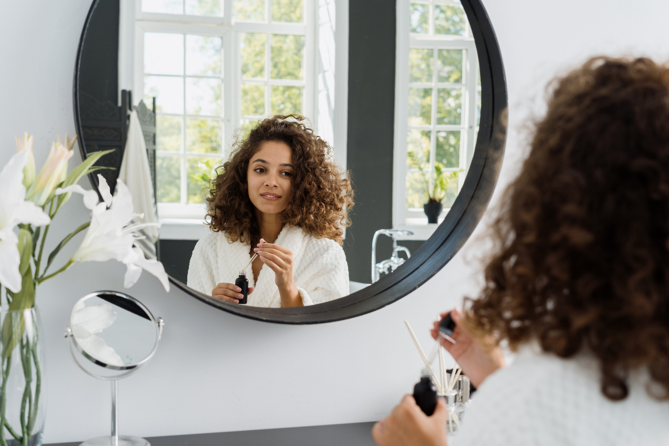 woman looking in mirror