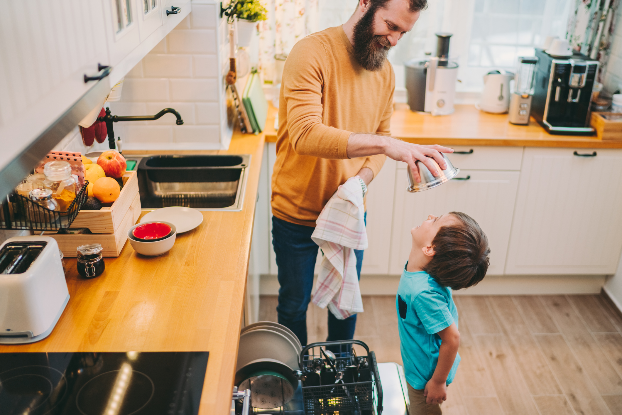 Family at home unloading the dishwasher