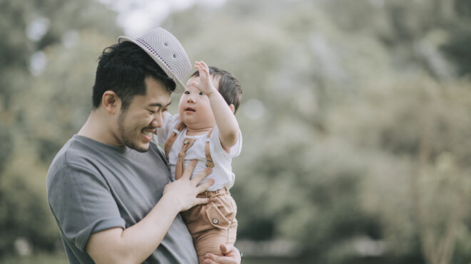 dad holds young son