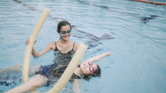 young asian girl swimming in pool