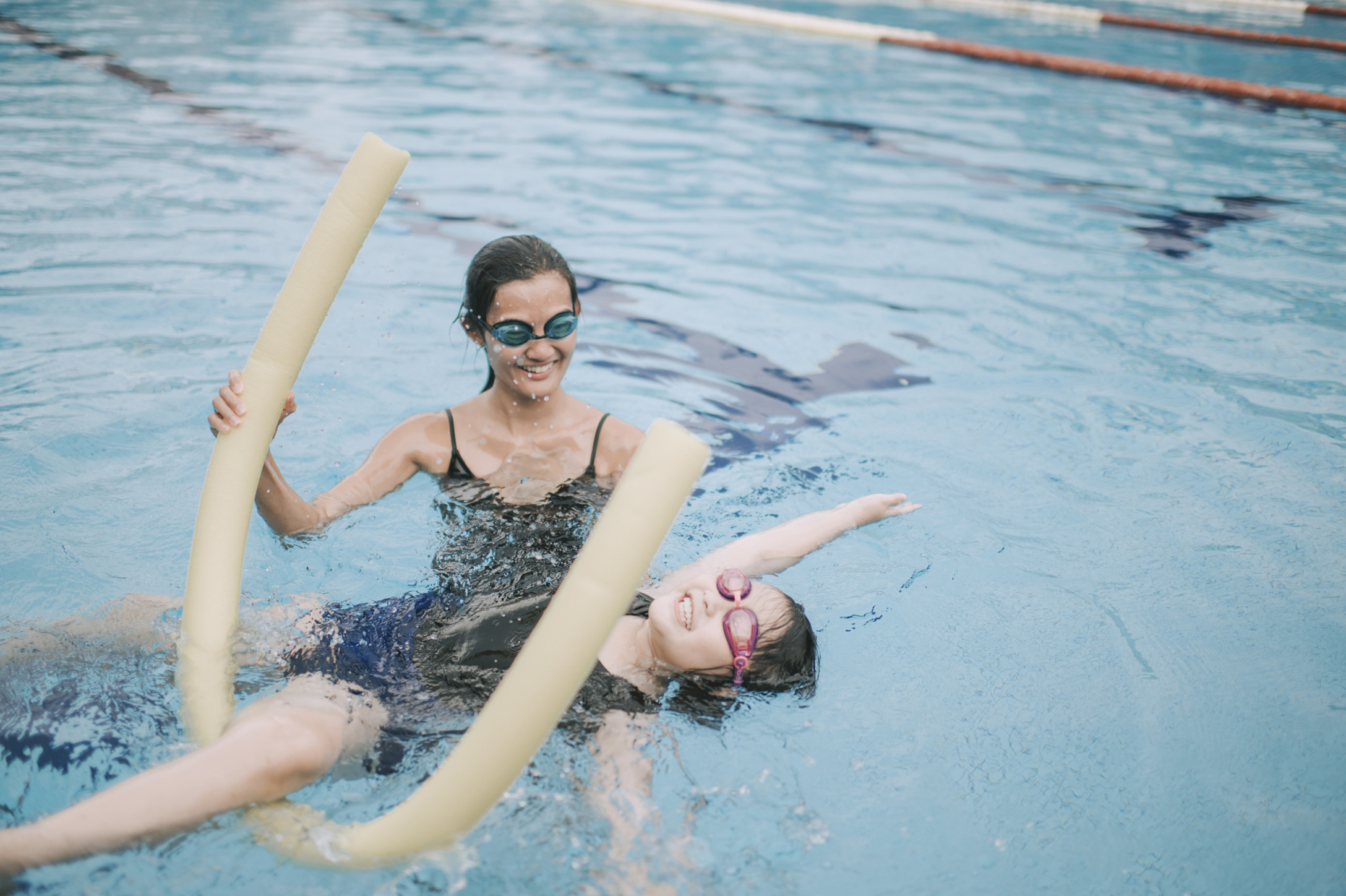 young asian girl swimming in pool