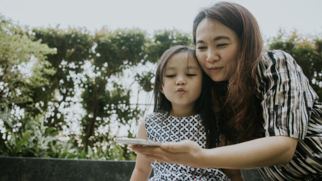 mom and daughter taking selfie