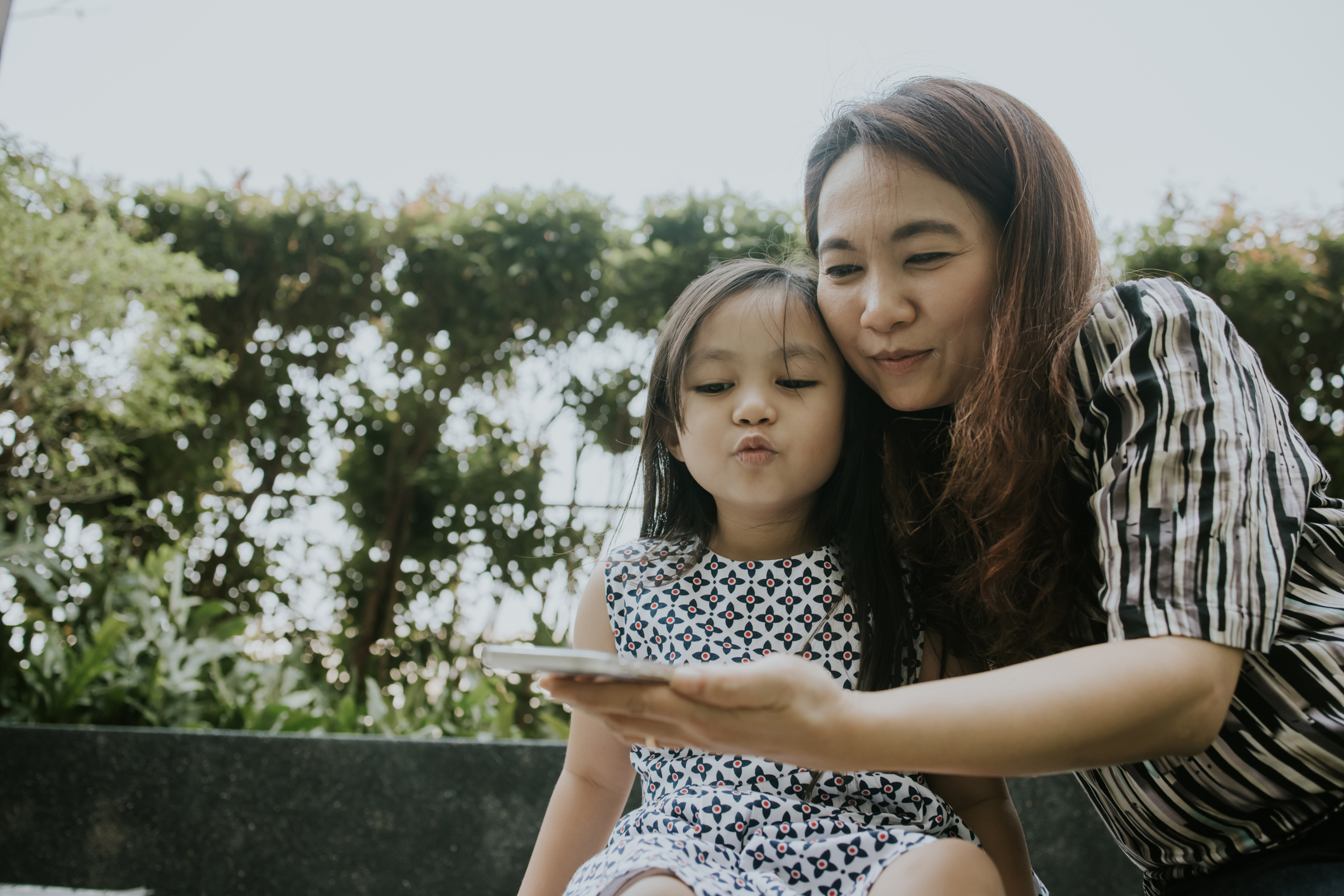 mom and daughter taking selfie
