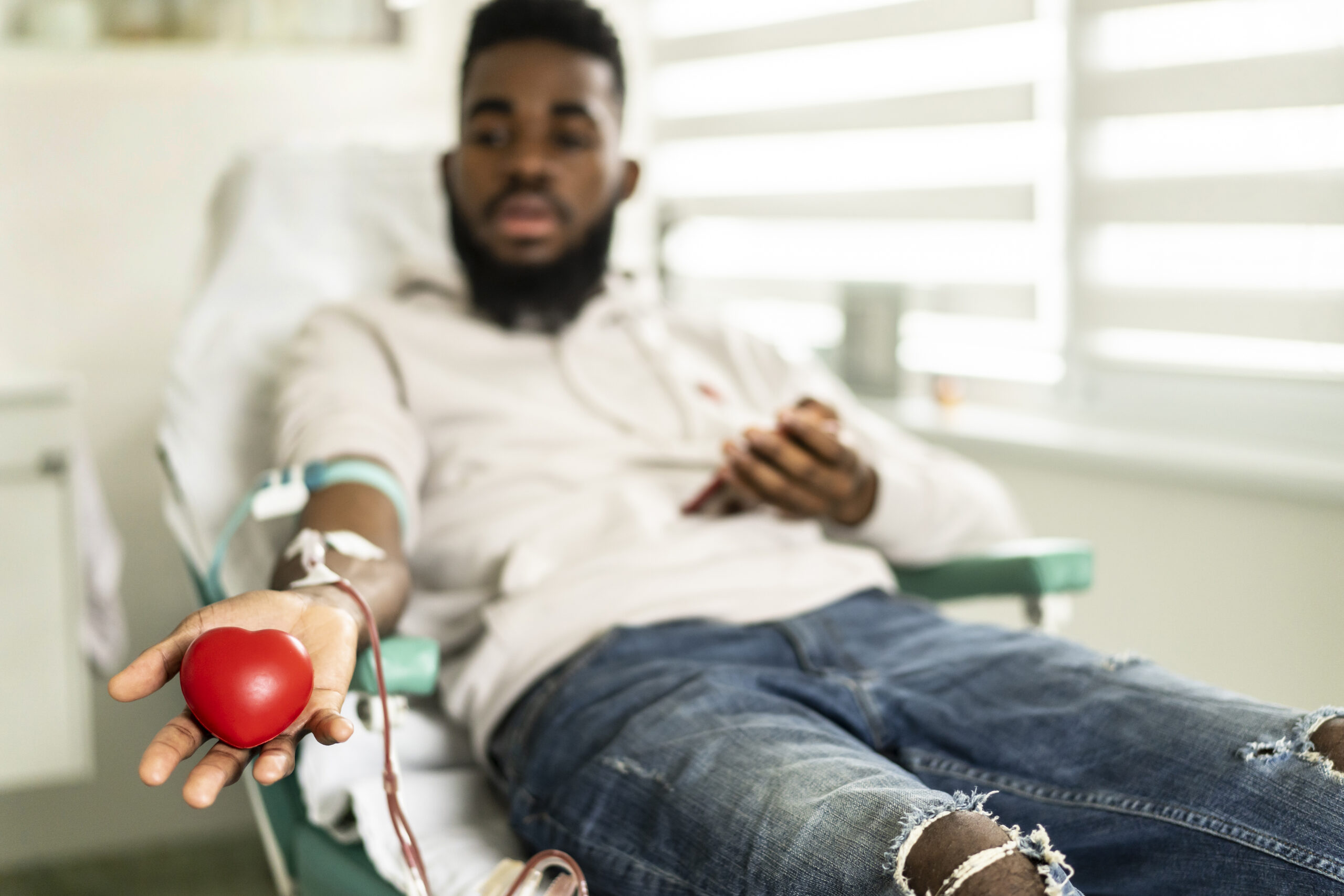 An african-american young man donating blood in the hospital