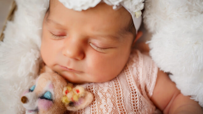 sleeping baby with stuffed animal