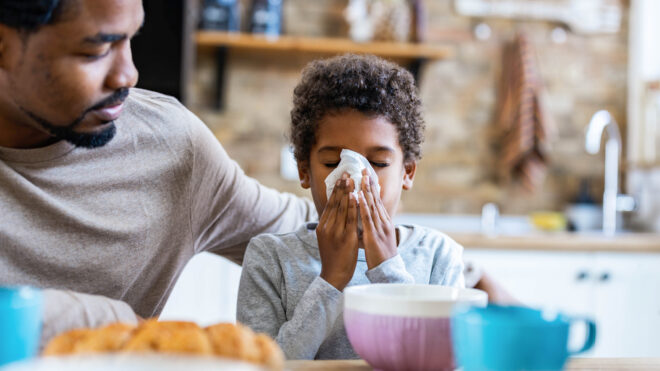 child blowing nose