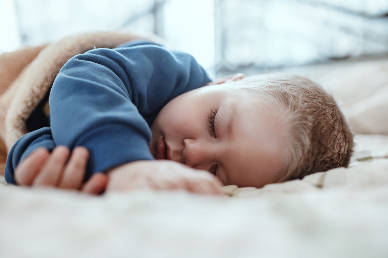 An adorable two years baby boy taking a nap