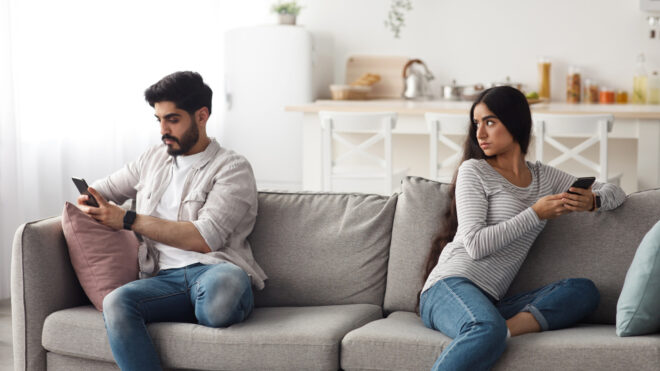 husband and wife sitting on couch