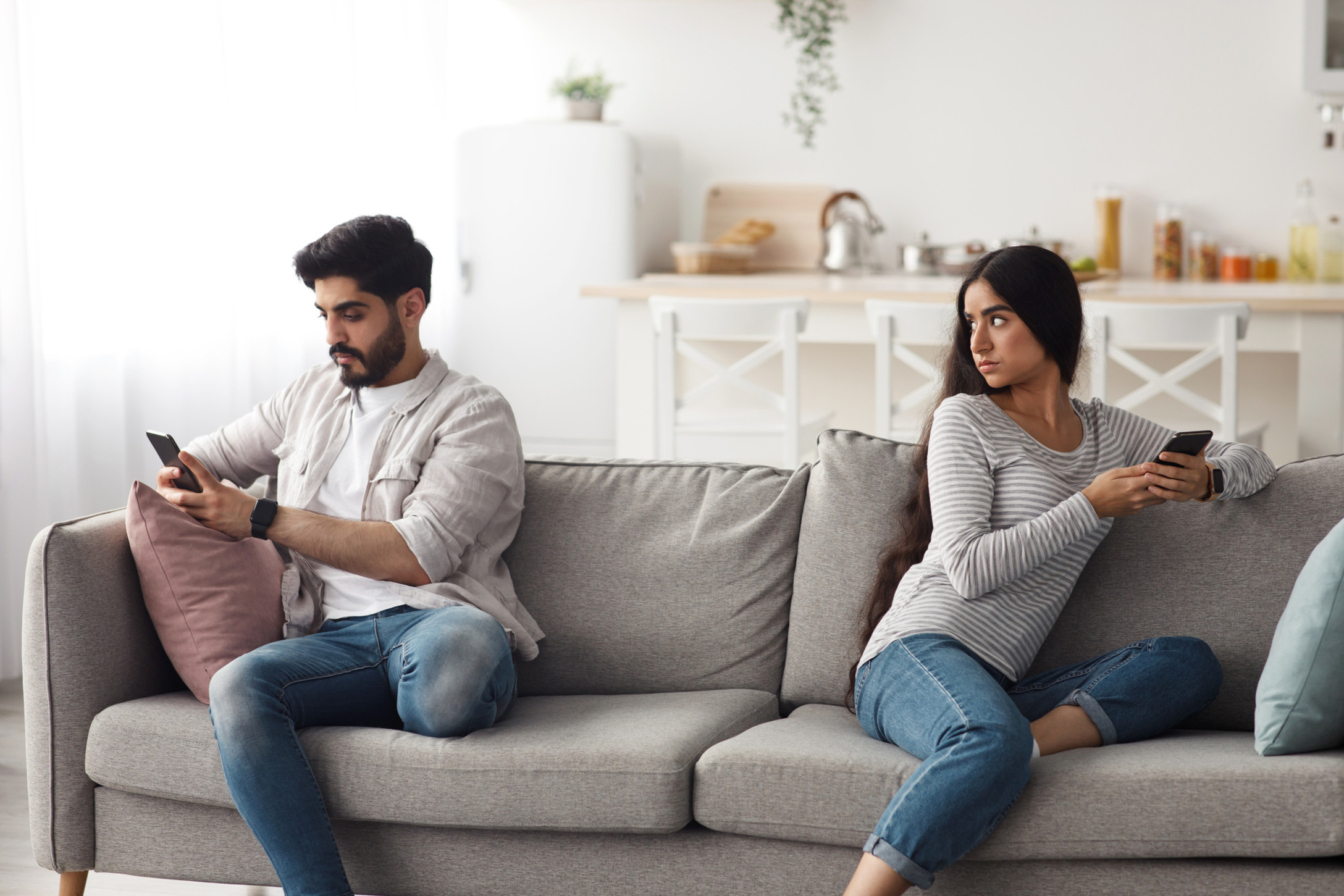 husband and wife sitting on couch