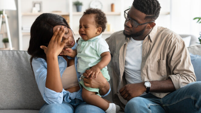 couple sitting with baby