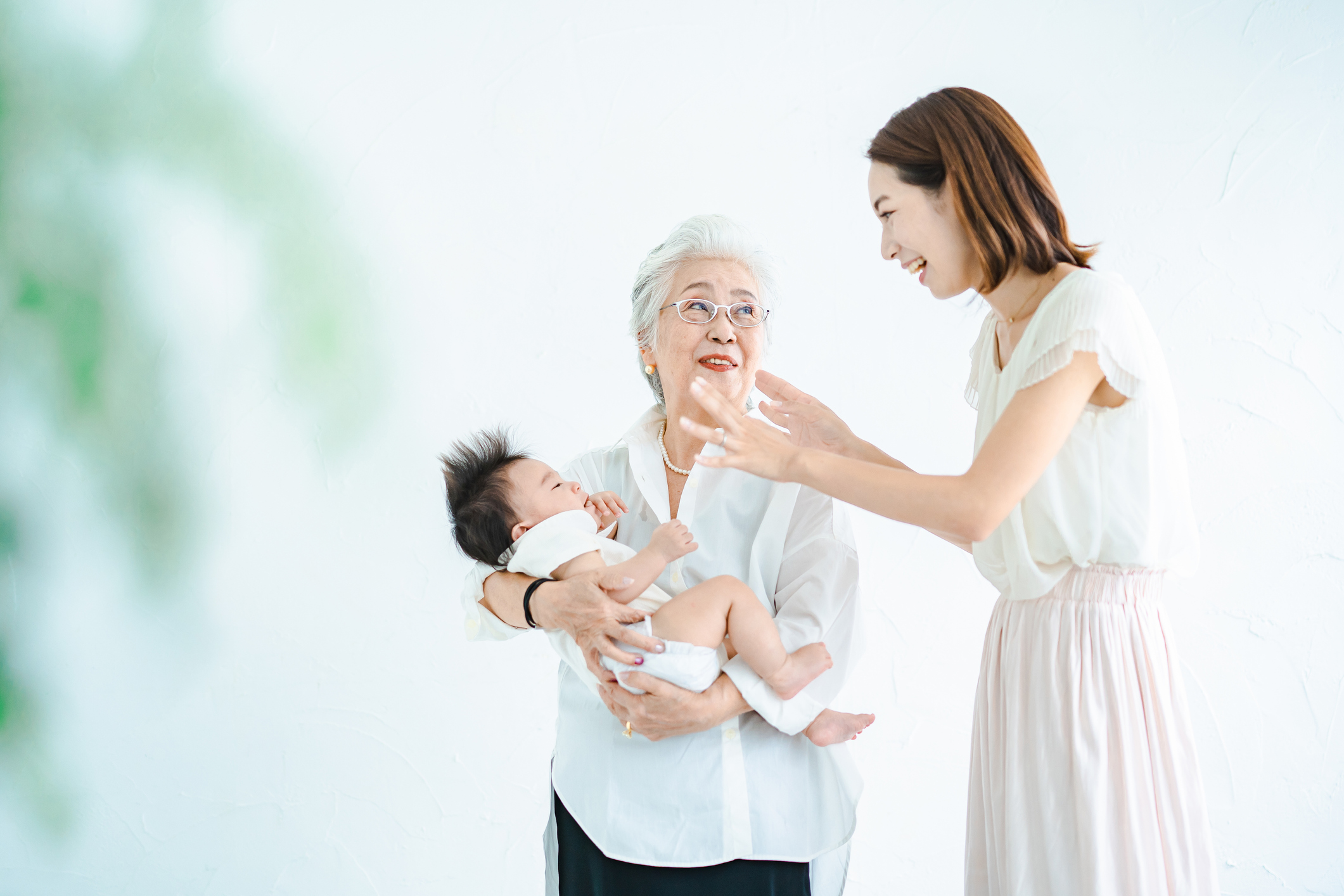 Senior women hugging babies and women