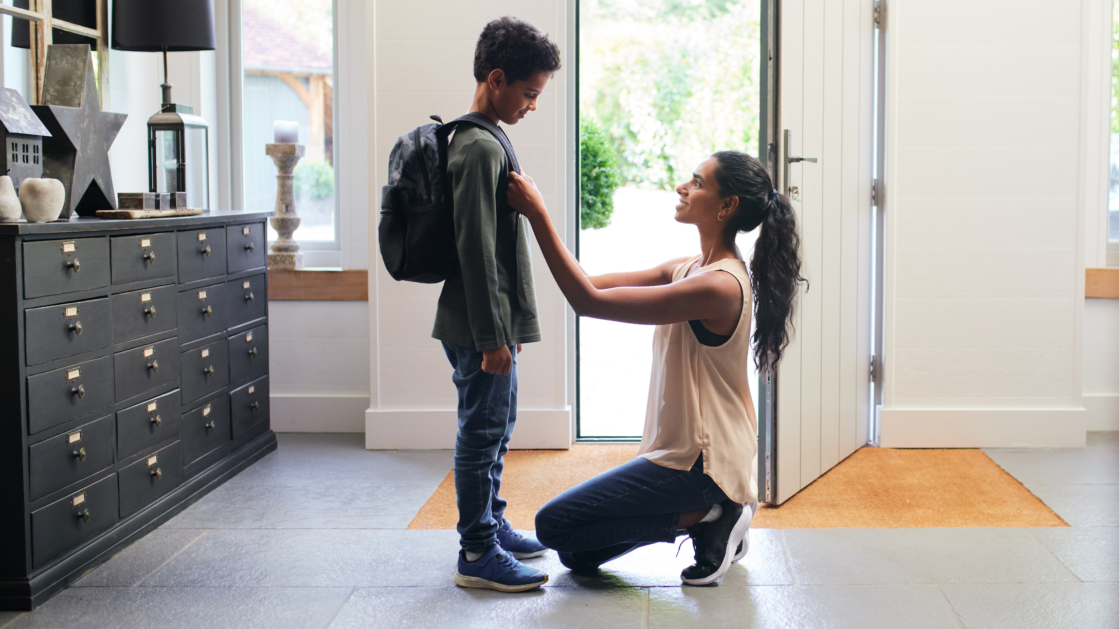 Mother helping son get ready for school