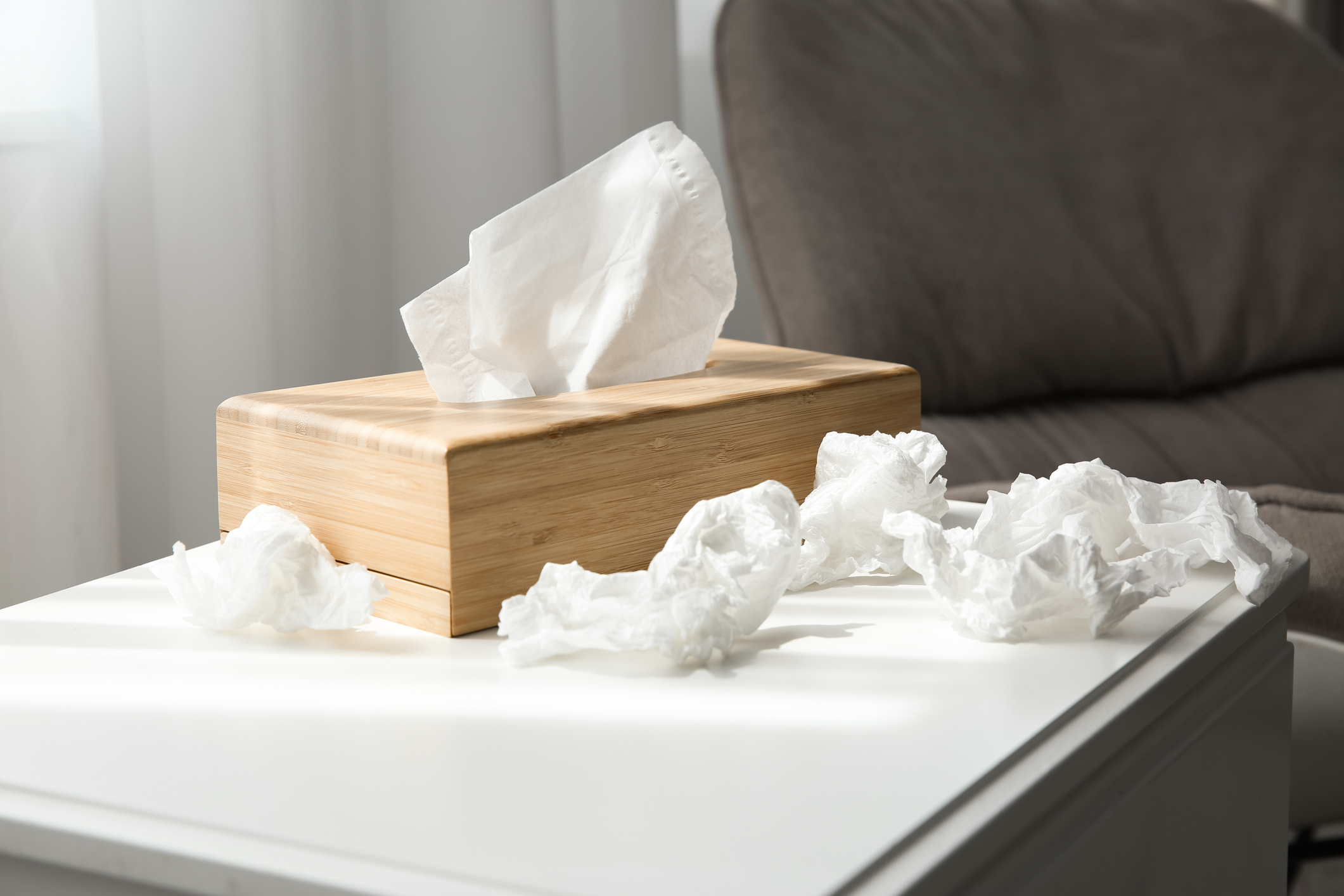 Used paper tissues and wooden holder on table indoors