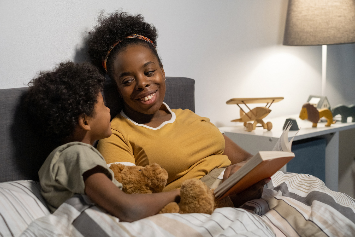 Cheerful Mother With Son In Bed