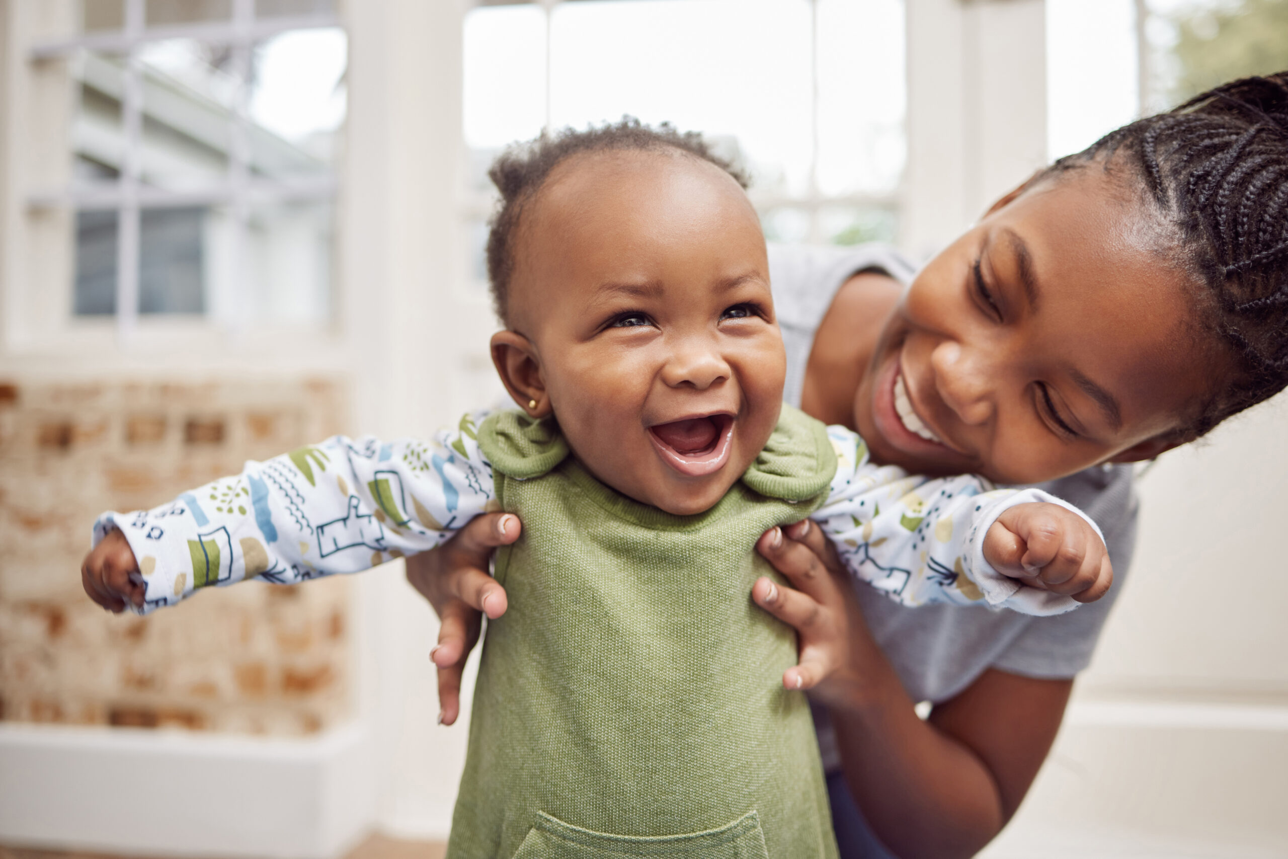 Shot of a young woman bonding with her baby at home