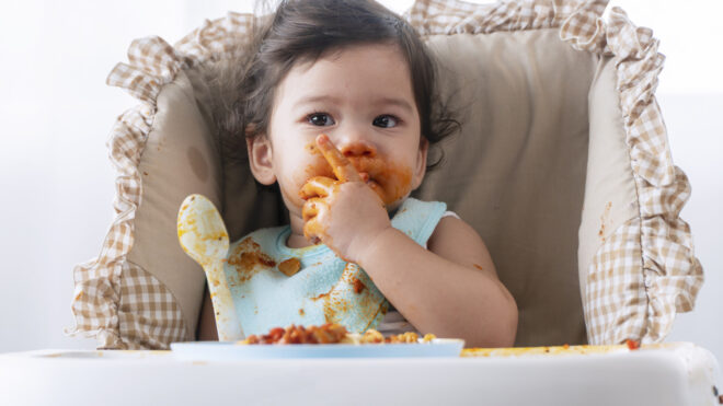 baby eating pasta