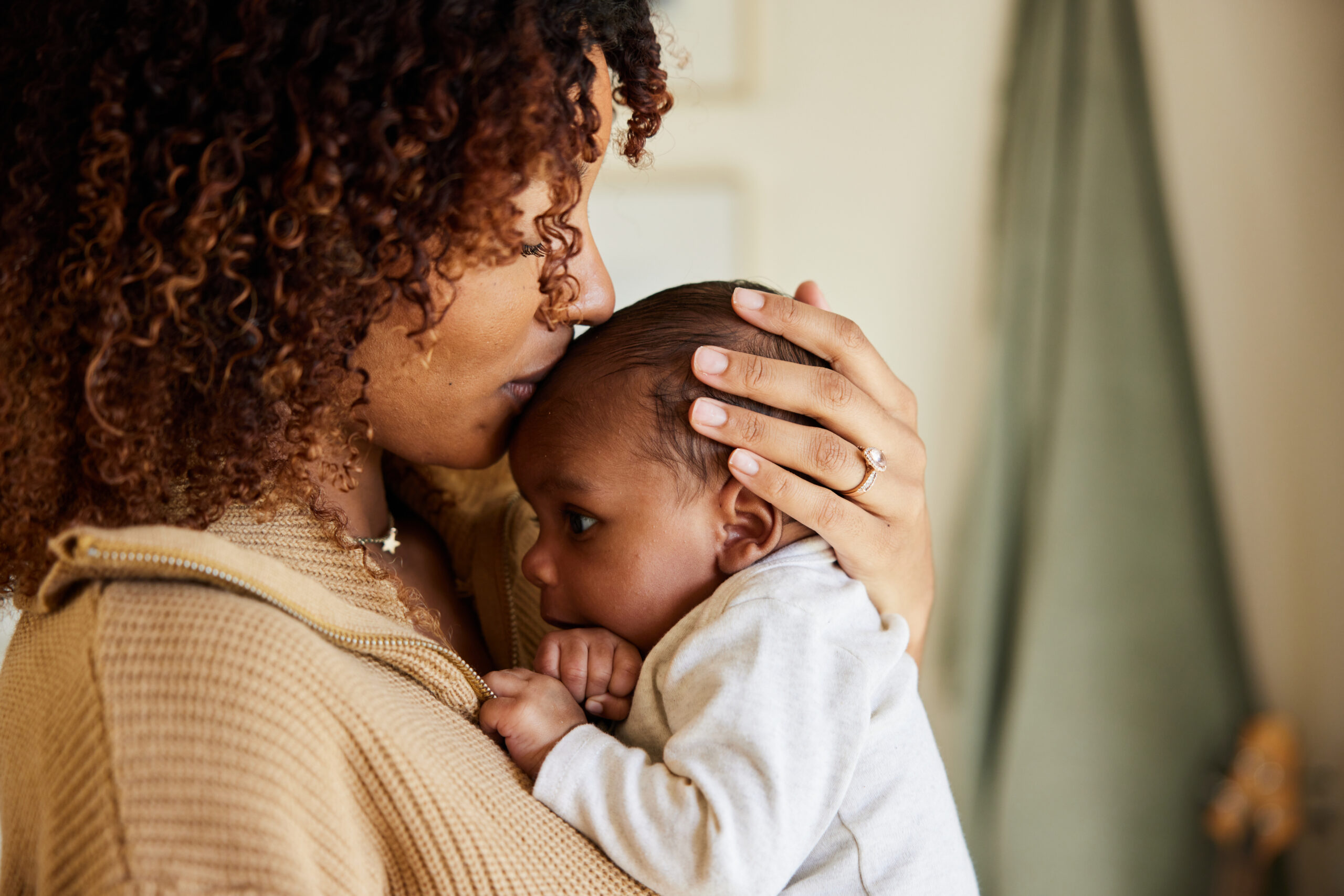 Mother kissing with her baby boy in her arms Mother kissing with her baby boy in her arms