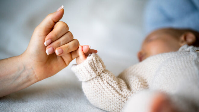 newborn holding mom's fingers