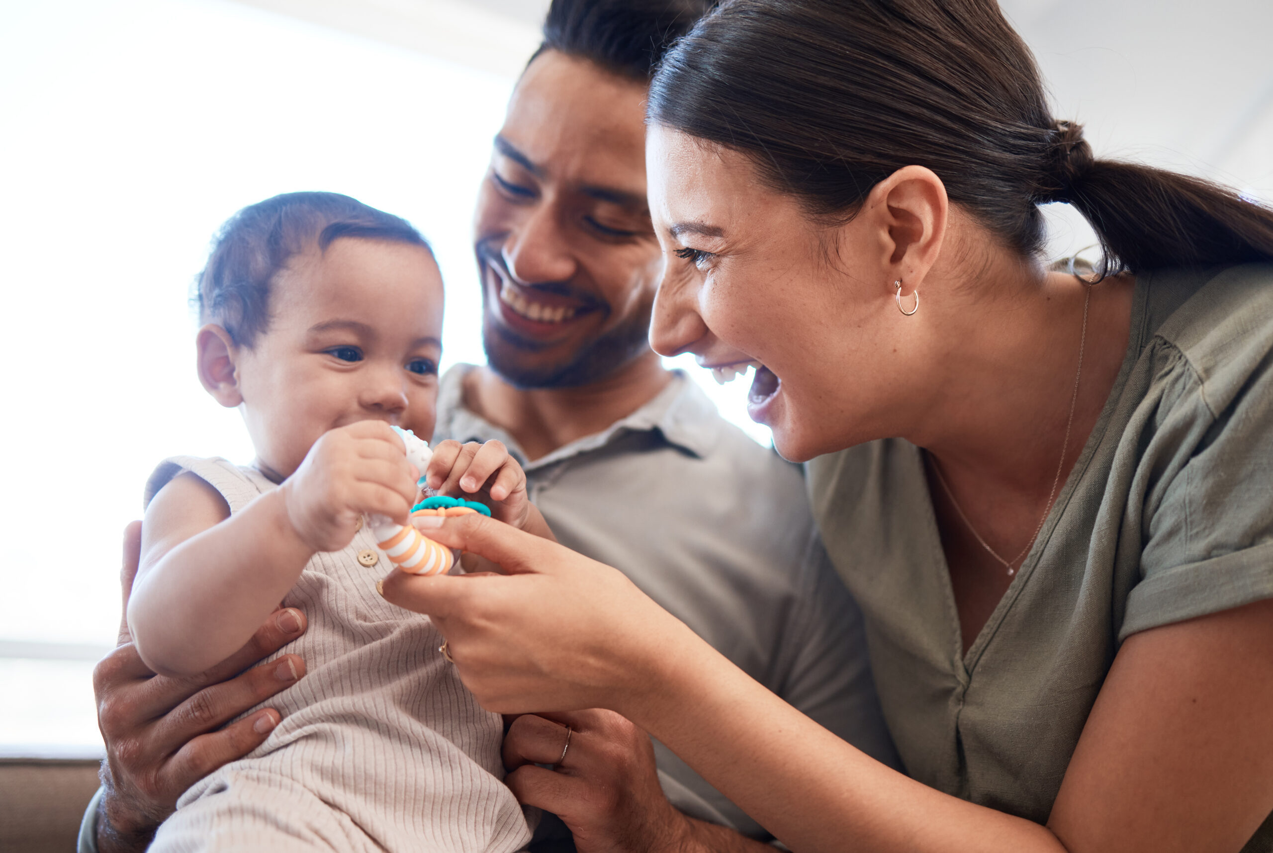Shot of a young couple bonding with their baby girl on a sofa at home