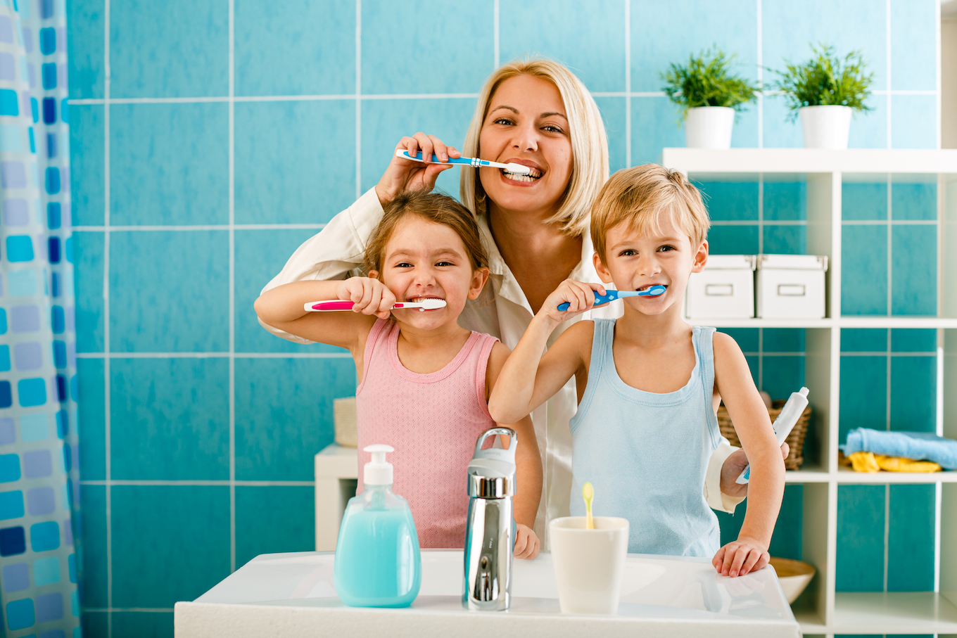 Family brushing teeth together in the bathroom