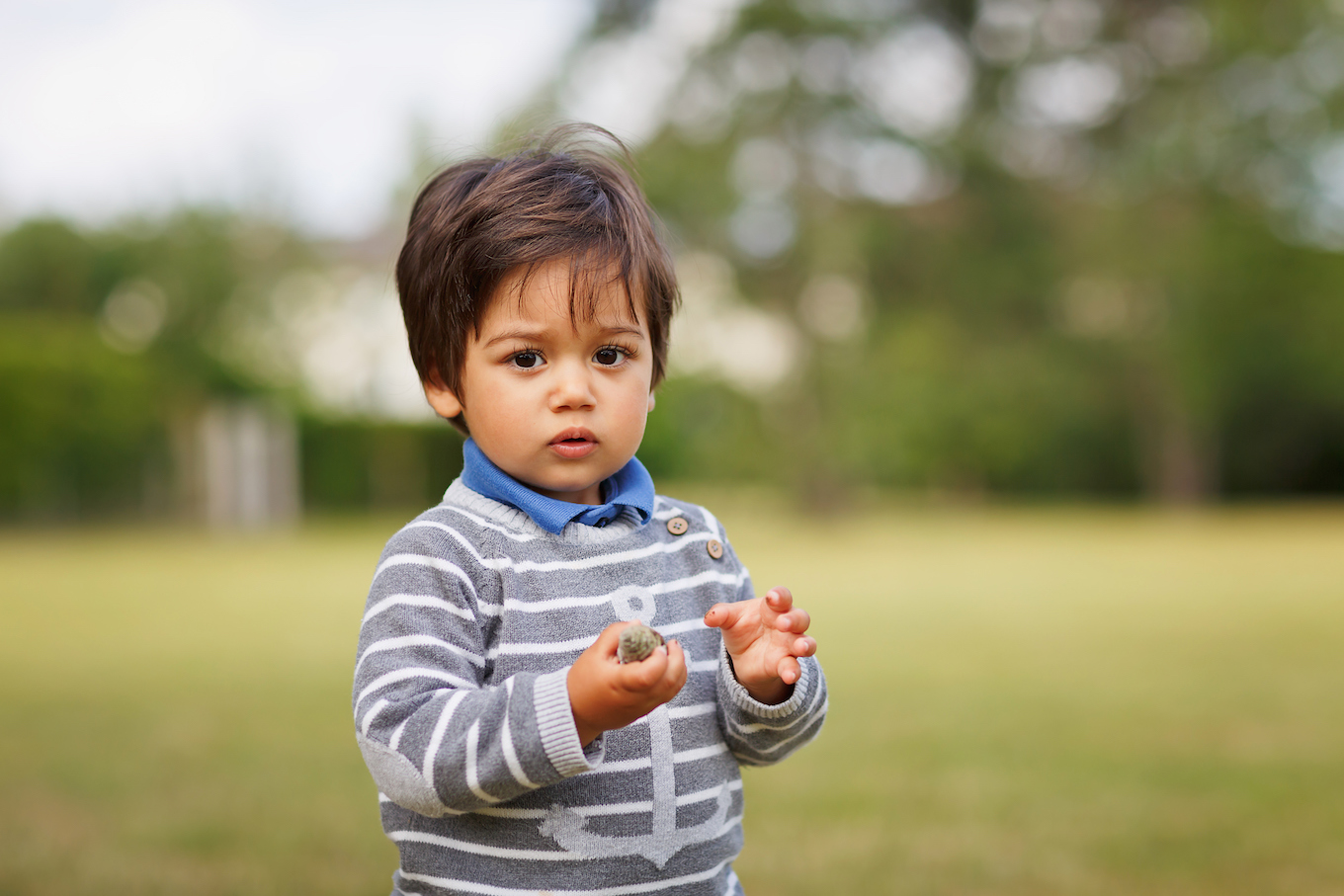 Little eastern handsome baby boy playing outdoor in the park