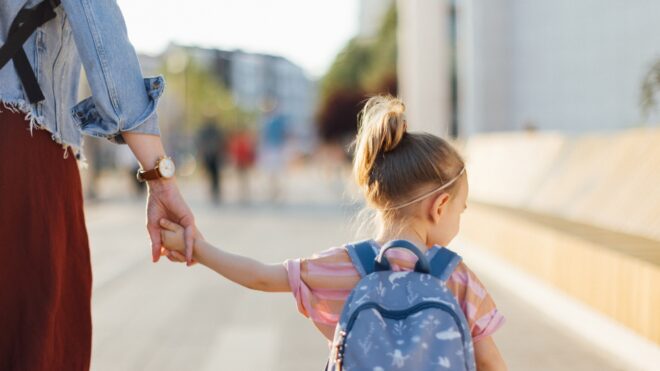 Mom holding her daughter's hand