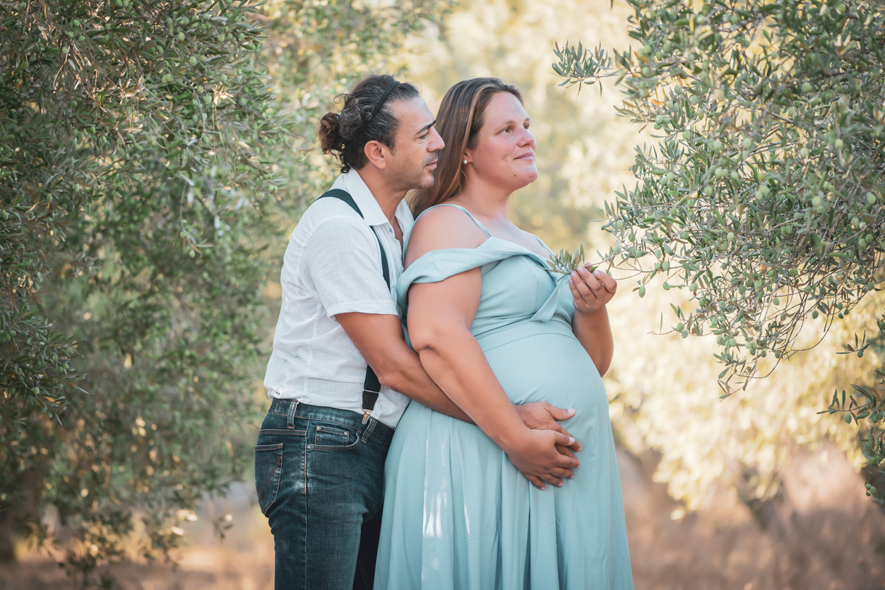 Future parents couple at olive orchard