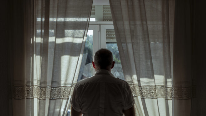 Man looking out of window
