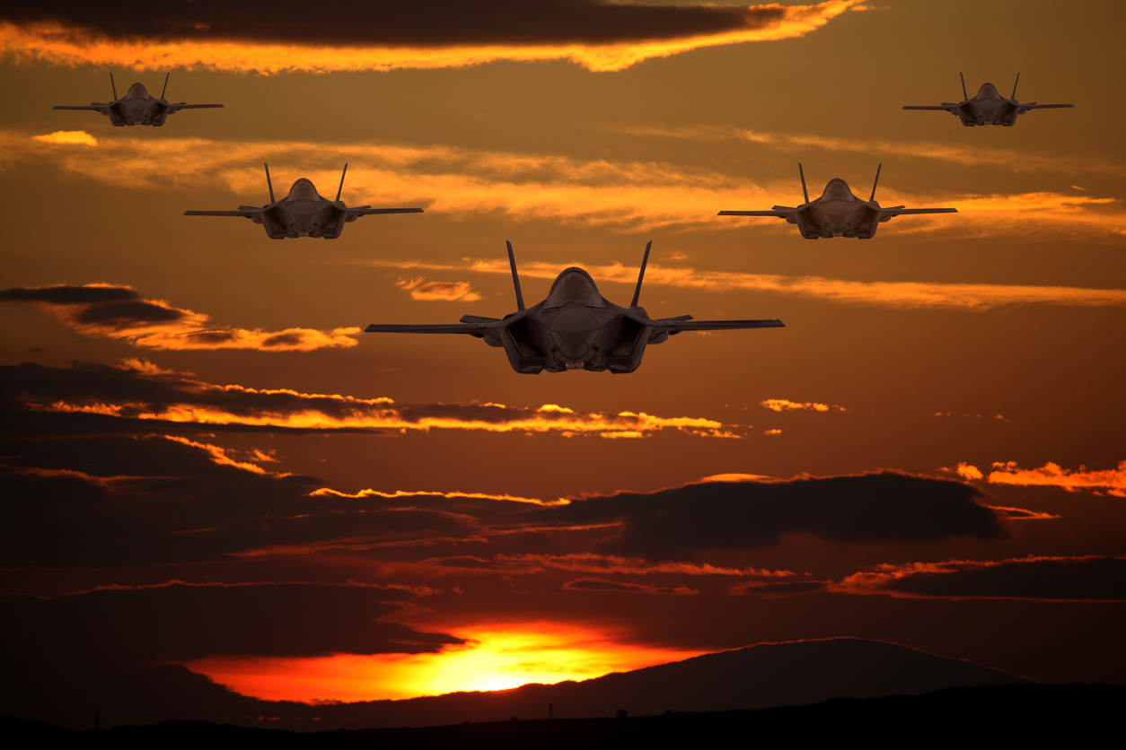 F-35 fighter jets flying over clouds