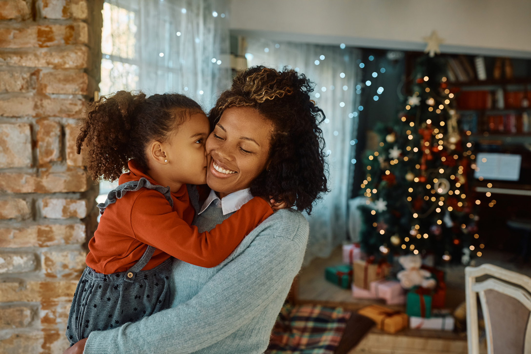 Affectionate mother and daughter spending Christmas together at home.