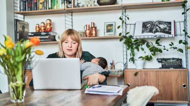 Mom holding baby at computer