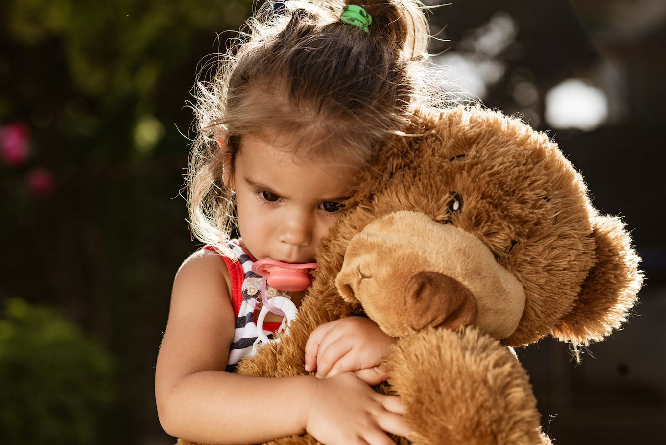 Beautiful but sad baby girl with her toy