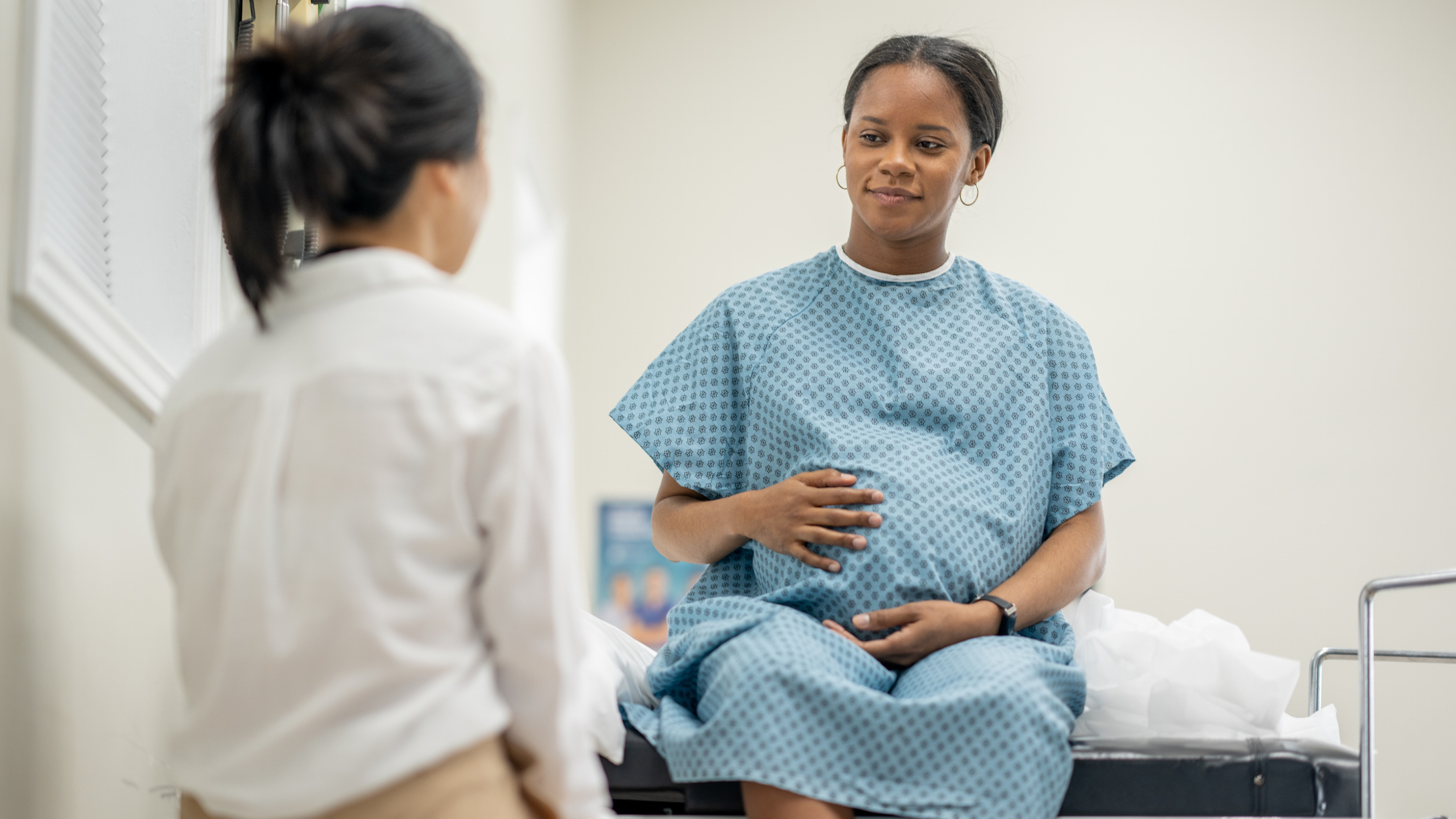 Pregnant woman talking to doctor main image