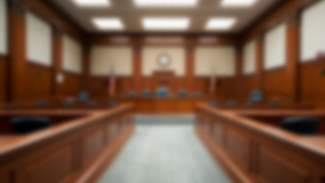 Blurred background of an empty courtroom.